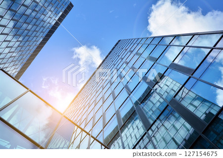 Modern sustainable glass office buildings. Exterior view of corporate headquarters glass buildings architecture.Glass windows in energy-efficient buildings. Financial business center buildings.  127154675
