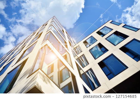 Modern sustainable glass office buildings. Exterior view of corporate headquarters glass buildings architecture.Glass windows in energy-efficient buildings. Financial business center buildings.  127154685