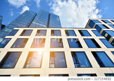 Modern sustainable glass office buildings. Exterior view of corporate headquarters glass buildings architecture.Glass windows in energy-efficient buildings. Financial business center buildings. Modern sustainable glass office buildings. Exterior view of corporate headquarters glass buildings architecture.Glass windows in energy-efficient buildings. Financial business center buildings. 127154692