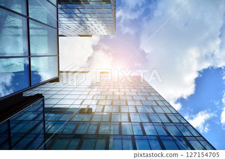 Modern sustainable glass office buildings. Exterior view of corporate headquarters glass buildings architecture.Glass windows in energy-efficient buildings. Financial business center buildings.  127154705