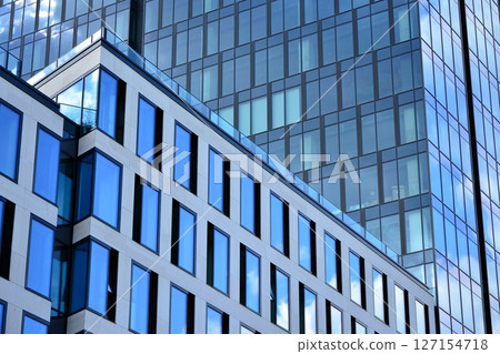 Modern sustainable glass office buildings. Exterior view of corporate headquarters glass buildings architecture.Glass windows in energy-efficient buildings. Financial business center buildings.  127154718