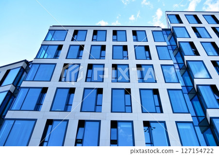 Modern sustainable glass office buildings. Exterior view of corporate headquarters glass buildings architecture.Glass windows in energy-efficient buildings. Financial business center buildings.  127154722