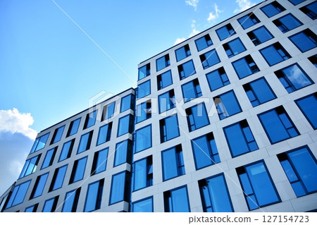 Modern sustainable glass office buildings. Exterior view of corporate headquarters glass buildings architecture.Glass windows in energy-efficient buildings. Financial business center buildings.  127154723