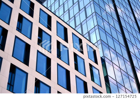Modern sustainable glass office buildings. Exterior view of corporate headquarters glass buildings architecture.Glass windows in energy-efficient buildings. Financial business center buildings.  127154725