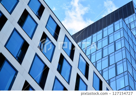Modern sustainable glass office buildings. Exterior view of corporate headquarters glass buildings architecture.Glass windows in energy-efficient buildings. Financial business center buildings.  127154727