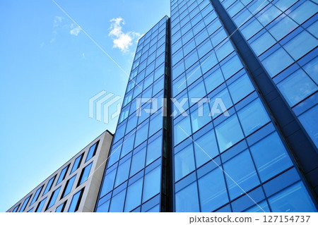 Modern sustainable glass office buildings. Exterior view of corporate headquarters glass buildings architecture.Glass windows in energy-efficient buildings. Financial business center buildings. Modern sustainable glass office buildings. Exterior view of corporate headquarters glass buildings architecture.Glass windows in energy-efficient buildings. Financial business center buildings. 127154737