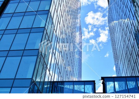 Modern sustainable glass office buildings. Exterior view of corporate headquarters glass buildings architecture.Glass windows in energy-efficient buildings. Financial business center buildings.  127154741