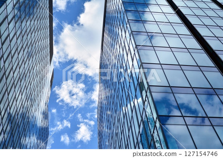 Modern sustainable glass office buildings. Exterior view of corporate headquarters glass buildings architecture.Glass windows in energy-efficient buildings. Financial business center buildings.  127154746