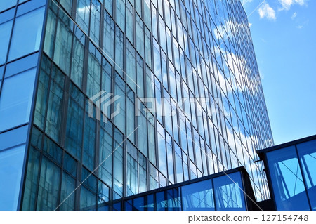 Modern sustainable glass office buildings. Exterior view of corporate headquarters glass buildings architecture.Glass windows in energy-efficient buildings. Financial business center buildings.  127154748