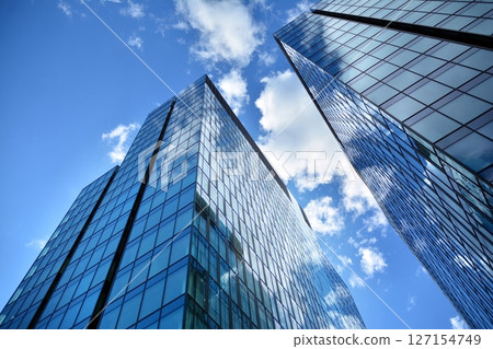 Modern sustainable glass office buildings. Exterior view of corporate headquarters glass buildings architecture.Glass windows in energy-efficient buildings. Financial business center buildings.  127154749
