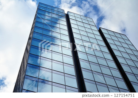 Modern sustainable glass office buildings. Exterior view of corporate headquarters glass buildings architecture.Glass windows in energy-efficient buildings. Financial business center buildings.  127154751