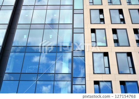 Modern sustainable glass office buildings. Exterior view of corporate headquarters glass buildings architecture.Glass windows in energy-efficient buildings. Financial business center buildings.  127154768