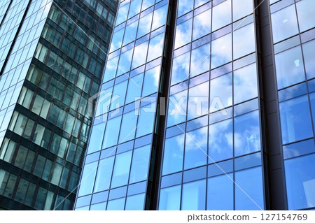 Modern sustainable glass office buildings. Exterior view of corporate headquarters glass buildings architecture.Glass windows in energy-efficient buildings. Financial business center buildings.  127154769