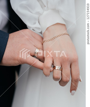 close-up of the bride and groom's hand with rings on their fingers. High quality photo close-up of the bride and groom's hand with rings on their fingers. High quality photo 127154910
