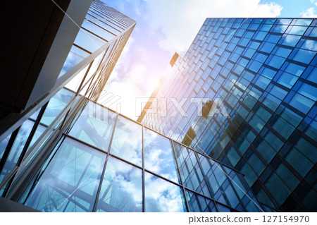 Modern sustainable glass office buildings. Exterior view of corporate headquarters glass buildings architecture.Glass windows in energy-efficient buildings. Financial business center buildings. Modern sustainable glass office buildings. Exterior view of corporate headquarters glass buildings architecture.Glass windows in energy-efficient buildings. Financial business center buildings. 127154970