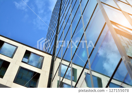 Modern sustainable glass office buildings. Exterior view of corporate headquarters glass buildings architecture.Glass windows in energy-efficient buildings. Financial business center buildings. Modern sustainable glass office buildings. Exterior view of corporate headquarters glass buildings architecture.Glass windows in energy-efficient buildings. Financial business center buildings. 127155078