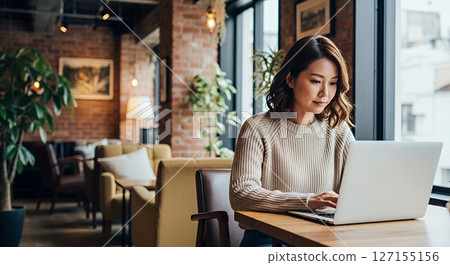 Woman doing remote work in cafe 127155156