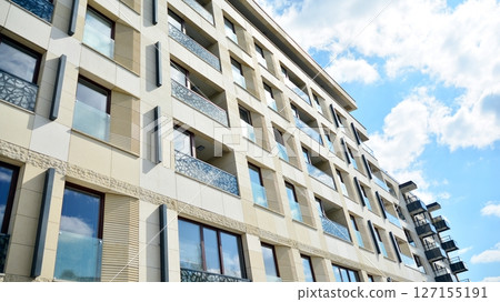 Modern new residential apartment house building complex. Exterior view of modern apartment building. New construction apartment or condo complex. 127155191