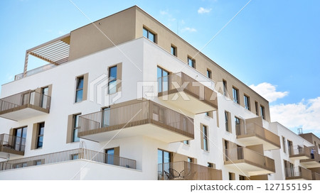Modern new residential apartment house building complex. Exterior view of modern apartment building. New construction apartment or condo complex. 127155195