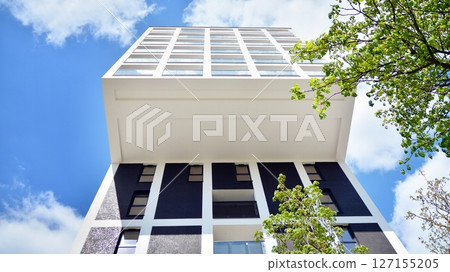 Modern new residential apartment house building complex. Exterior view of modern apartment building. New construction apartment or condo complex. 127155205