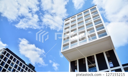 Modern new residential apartment house building complex. Exterior view of modern apartment building. New construction apartment or condo complex. 127155215
