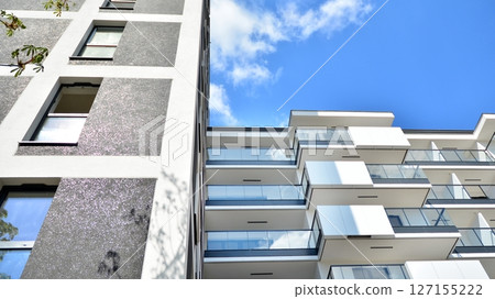 Modern new residential apartment house building complex. Exterior view of modern apartment building. New construction apartment or condo complex. Modern new residential apartment house building complex. Exterior view of modern apartment building. New construction apartment or condo complex. 127155222