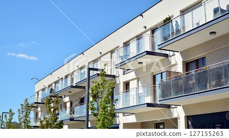 Modern new residential apartment house building complex. Exterior view of modern apartment building. New construction apartment or condo complex. 127155263