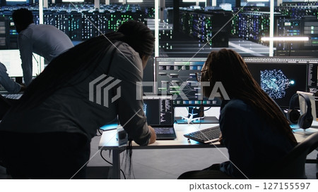 Data center teamworking colleagues use node tree program to identify equipment performance issues. Server hub engineering team coworkers review data analysis graph to minimize failures, camera A 127155597