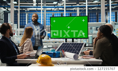 Managers in office reviewing solar technology reports on green screen monitor. Shareholders using mockup display, discussing investment opportunities in green energy production, camera A Managers in office reviewing solar technology reports on green screen monitor. Shareholders using mockup display, discussing investment opportunities in green energy production, camera A 127155707