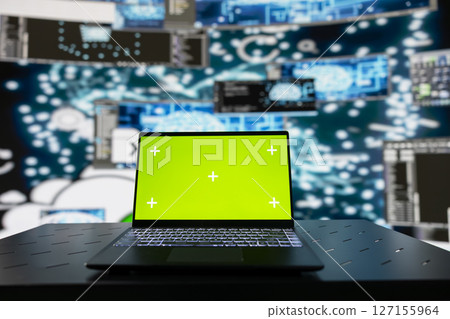 Surrounded by digital data and AI brain systems, laptop showcases green screen on a display. Automation platforms and cloud computing ensures a modern strategy and innovation. 127155964
