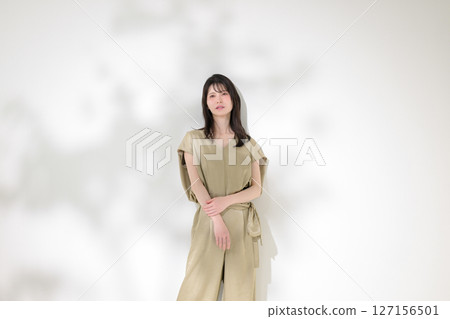 Middle-aged woman, sunlight filtering through the trees, beauty 127156501