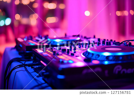 DJ setup glowing under vibrant club lights 127156781