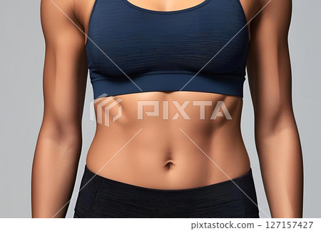Toned female athlete belly 127157427