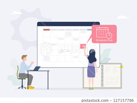 A PR rep schedules posts on social media while checking the calendar A PR rep schedules posts on social media while checking the calendar 127157786