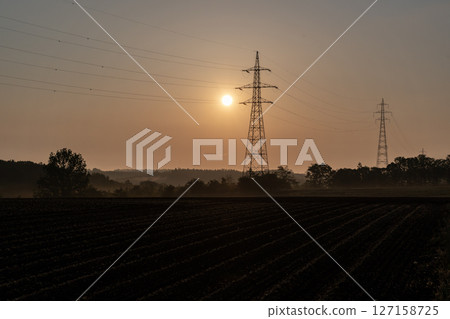 Electricity transmission tower in the morning mist 127158725