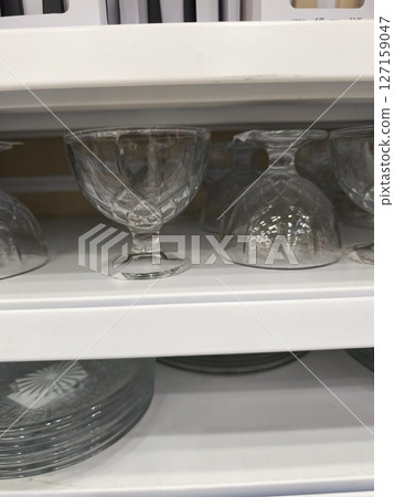 Elegant glass dessert cups arranged neatly on a shelf showcasing intricate designs and crystal clarity perfect for serving sweets and desserts healthy eating concept 127159047