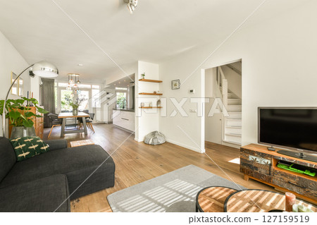 A stylish modern living room featuring comfortable furniture, bright decor, and an inviting atmosphere, perfect for relaxation and social gatherings. A stylish modern living room featuring comfortable furniture, bright decor, and an inviting atmosphere, perfect for relaxation and social gatherings. 127159519