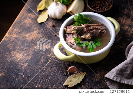 Boiled bone broth or bouillon with meat 127159615