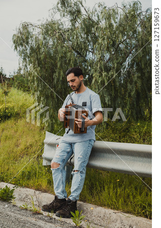 Man Inspired In The Nature While Playing Accordion 127159673