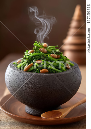 Salad of fermented tea leaves and crispy beans hand-tossed in dark bowl. Warm twilight tones, steam rising highlights natural ingredients. Concept of culinary arts, Asian cuisine, healthy eating Salad of fermented tea leaves and crispy beans hand-tossed in dark bowl. Warm twilight tones, steam rising highlights natural ingredients. Concept of culinary arts, Asian cuisine, healthy eating 127159818