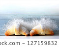 Almond croissants topped with sugar dusting display minimalist style against white backdrop. Fresh bakery setting evokes warmth and indulgence. Concept of pastry shops, cafes, gourmet food 127159832