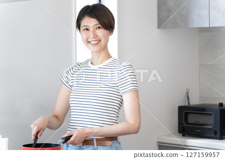 Woman cooking in the kitchen Woman cooking in the kitchen 127159957