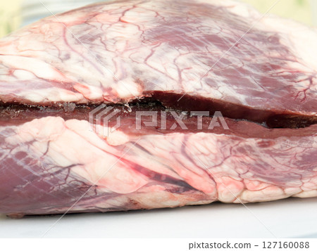 Raw frozen beef heart. 127160088