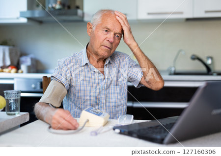 Modern elderly man sit at home having online consultation with doctor on computer, sick senior male talk on video call consulting using laptop. Healthcare concept 127160306