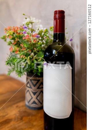 Welcome bottle of red wine and flowers 127160512