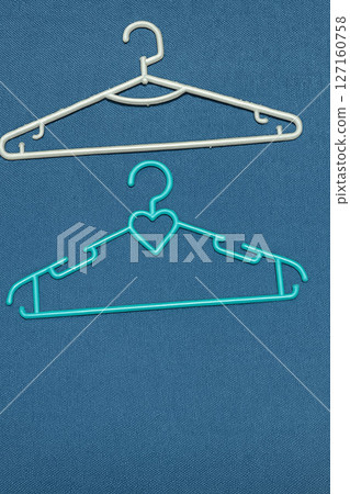 Two Plastic Clothes Hangers on Minimal Background 127160758