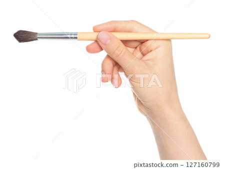 Woman hand holds paint brush, isolated on transparent background, painting and design concept 127160799