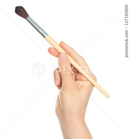 Woman hand holds paint brush, isolated on transparent background, painting and design concept 127160800