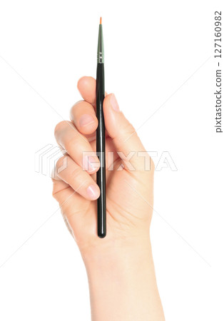 Woman hand holds black cosmetics brush, isolated on transparent background, cosmetics and visage concept 127160982