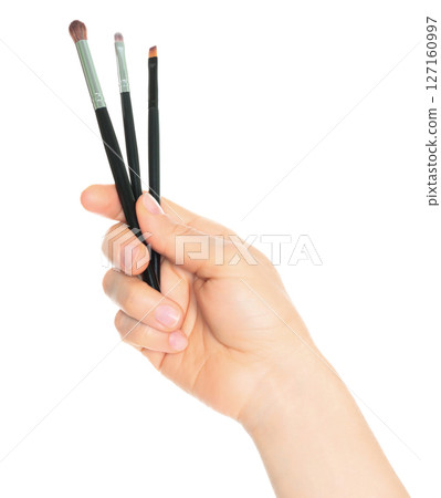 Woman hand holds Cosmetics Brushes, isolated on transparent background, cosmetics and visage concept 127160997